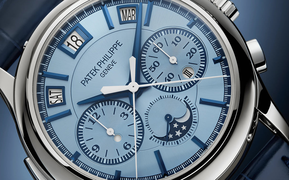 Close-up of Patek Philippe blue dial luxury mechanical wristwatch with date, day, month, and moon phase indicators