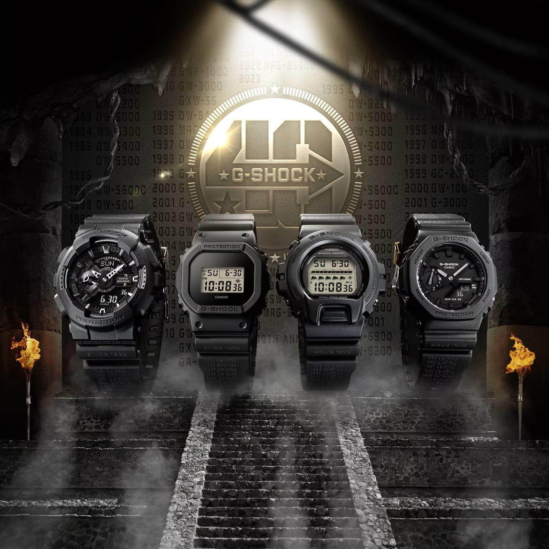 Four black Casio G-Shock watches displayed on stone steps with ancient temple background and flaming torches