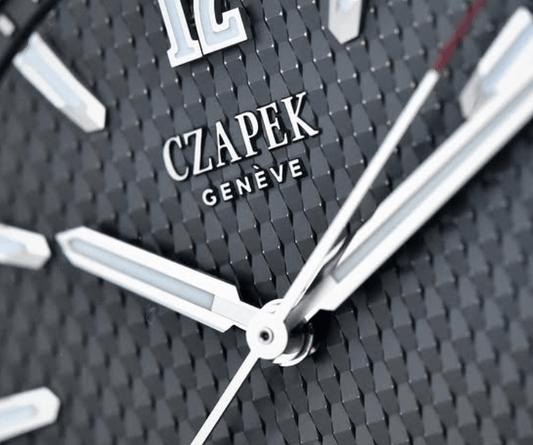 Close-up of CZAPEK Genève luxury watch dial with textured black pattern and silver hands