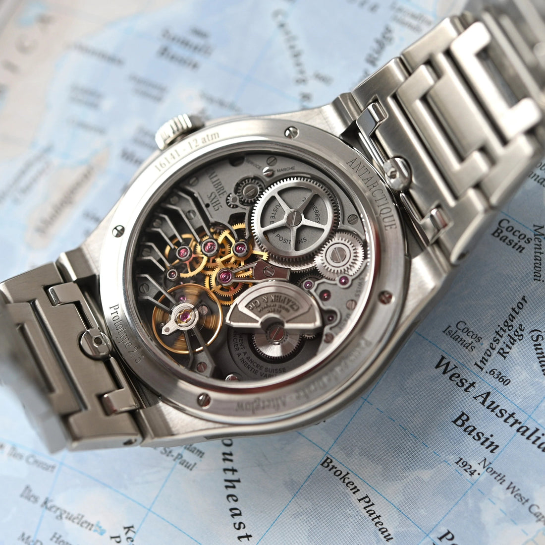 Close-up of Contévanou Czapek Antarctique watch's intricate mechanical movement on a map background