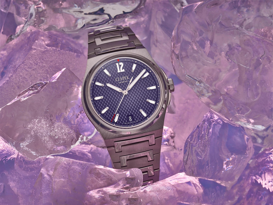 Czapek Antarctique Afterglow stainless steel watch with blue textured dial amidst purple ice blocks