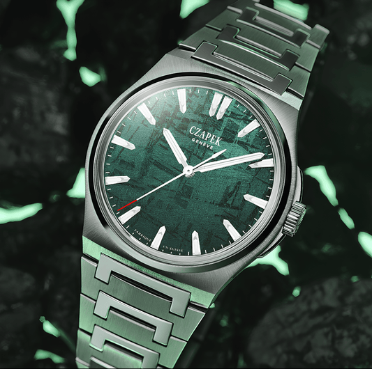 Luxury stainless steel watch with green textured dial and bold hour markers, close-up