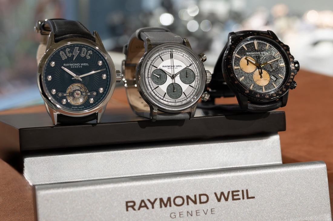 Three Raymond Weil Geneva men's luxury watches with unique dials on display