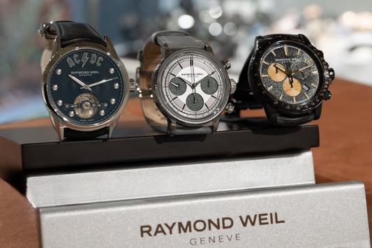 Three Raymond Weil Geneva men's luxury watches with unique dials on display