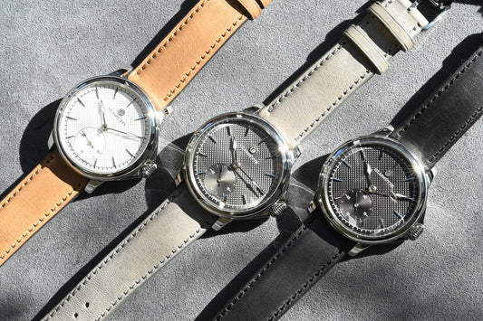 CONTÉVANOU mechanical wristwatches with textured dials and leather straps on gray background