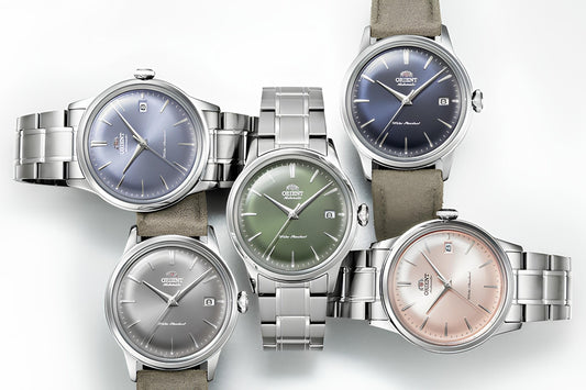 CONTÉVANOU collection of five Orient mechanical wristwatches with colorful dials and stainless steel bands.