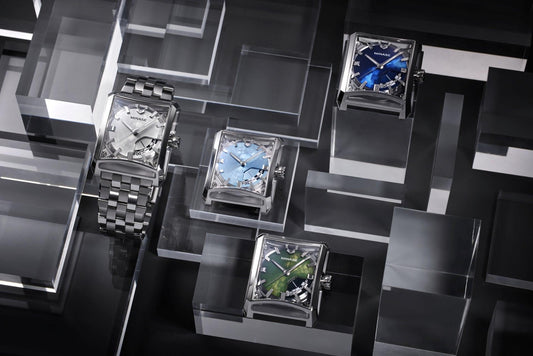 Contévanou collection of MINASE mechanical watches with square cases in silver, blue, light blue and green dials on clear acrylic blocks