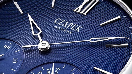 Close-up of a blue guilloché dial on a Czapek Genève mechanical wristwatch with silver hands and markers
