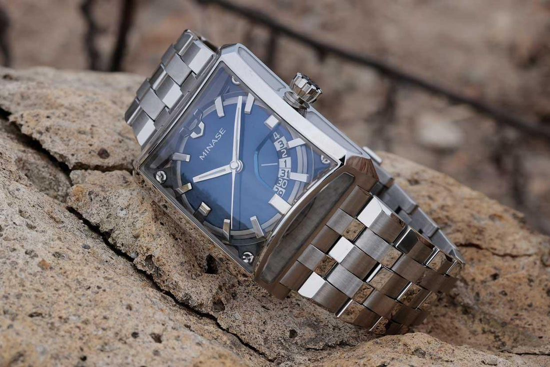 Contévanou MINASE square mechanical watch with blue dial and silver metal bracelet on textured rock