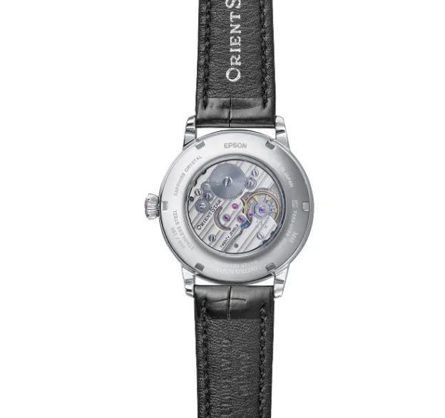 Luxury mechanical watch with transparent case back and black leather strap, showcasing movement.